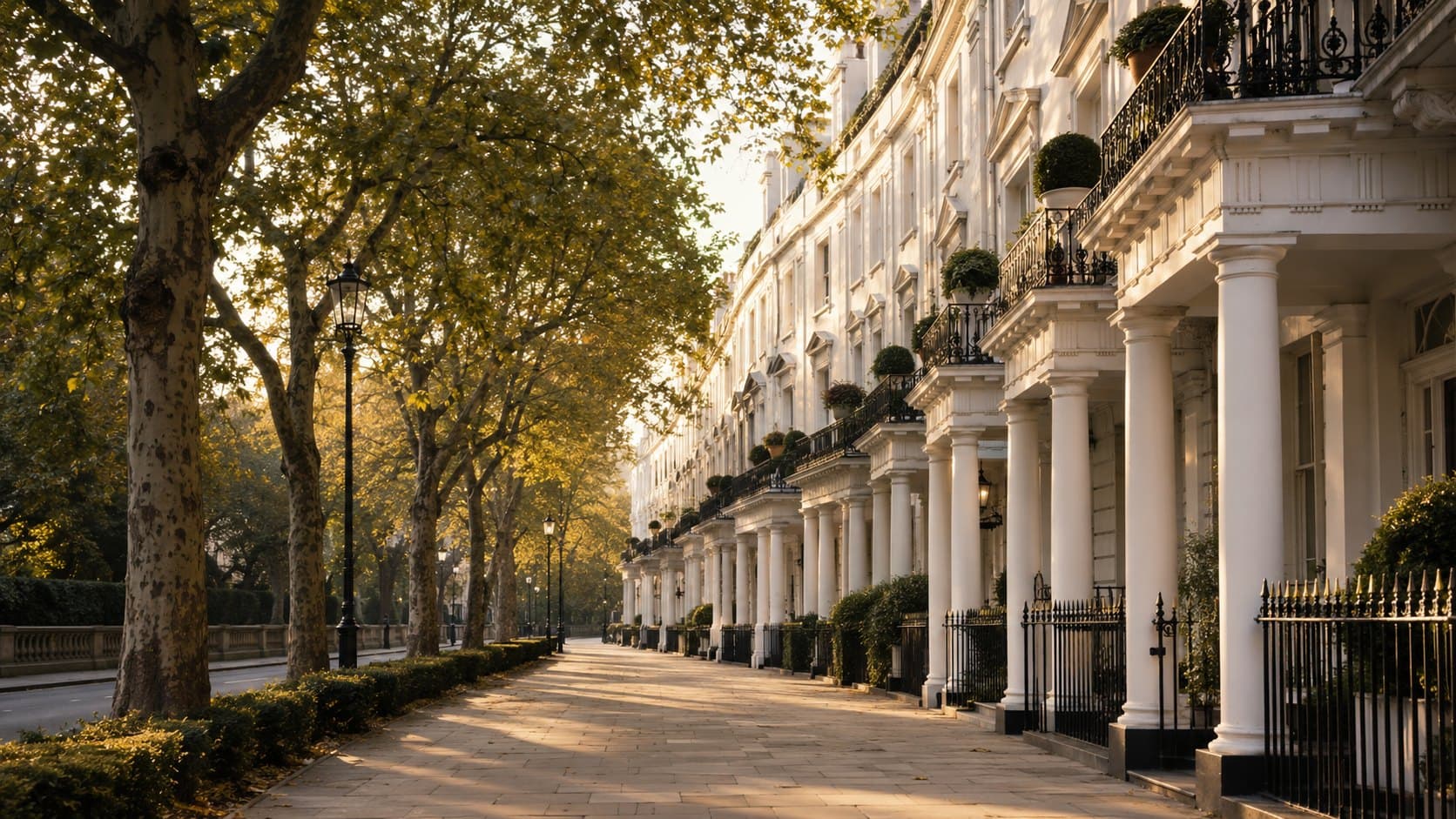 A crescent of white stucco townhouses on a tree-lined avenue near Hyde Park, Bayswater